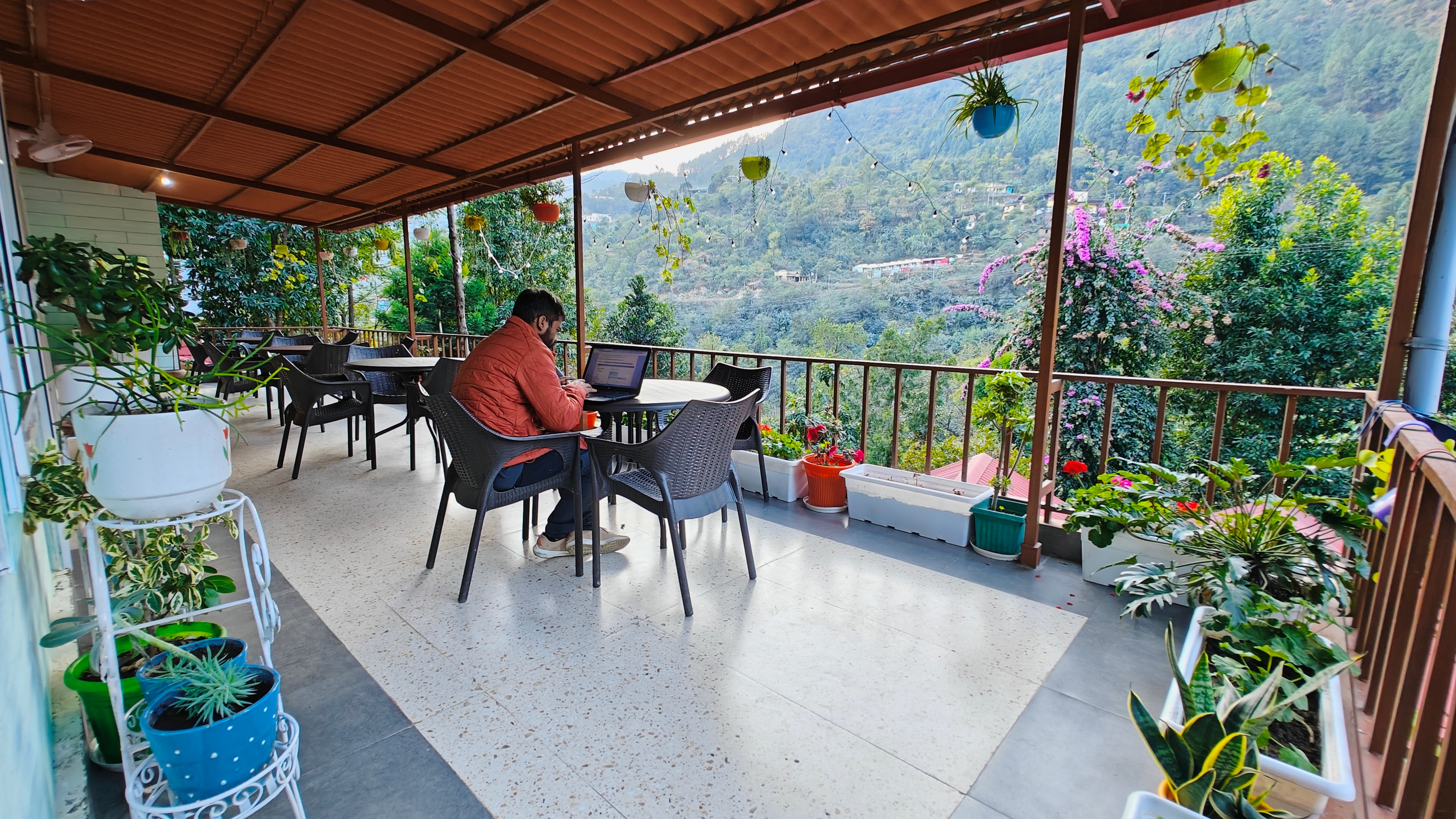A serene view of the Vedant Valley Lodge surrounded by lush greenery.